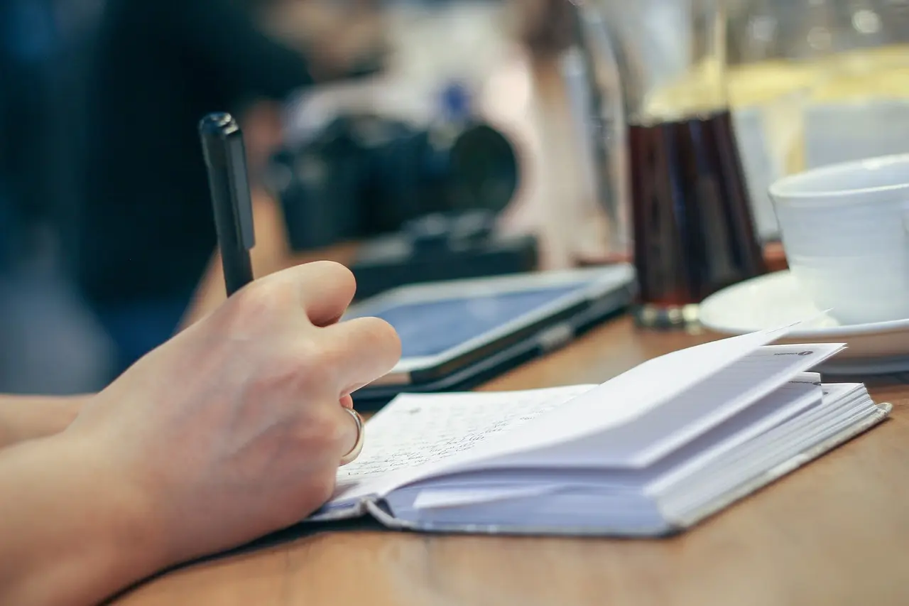 A person confronting procrastination at their desk