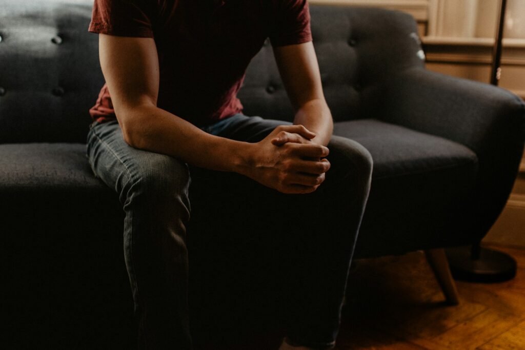 man sitting on sofa