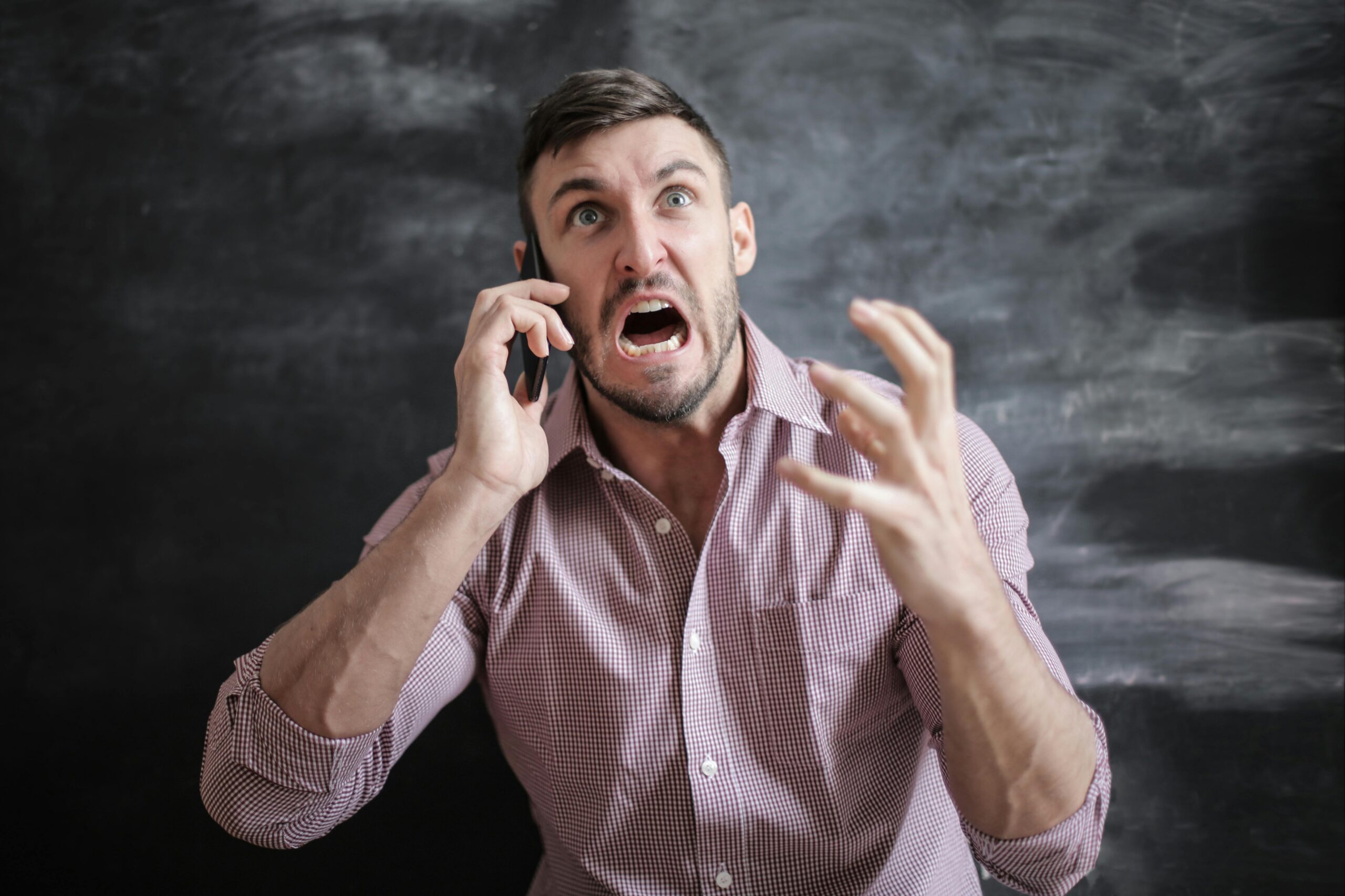 angry man talking on a phone